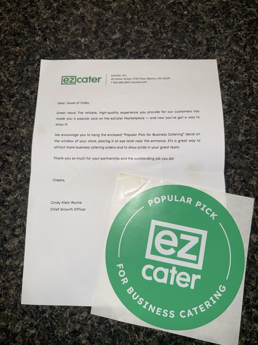 Letter from ezCater naming Jewel of India a Popular Pick for Business Catering, with the accompanying window decal