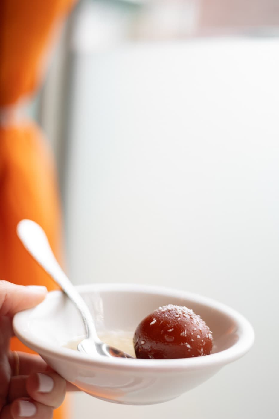 Gulab jamun dessert in a small ceramic bowl at Jewel of India Seattle