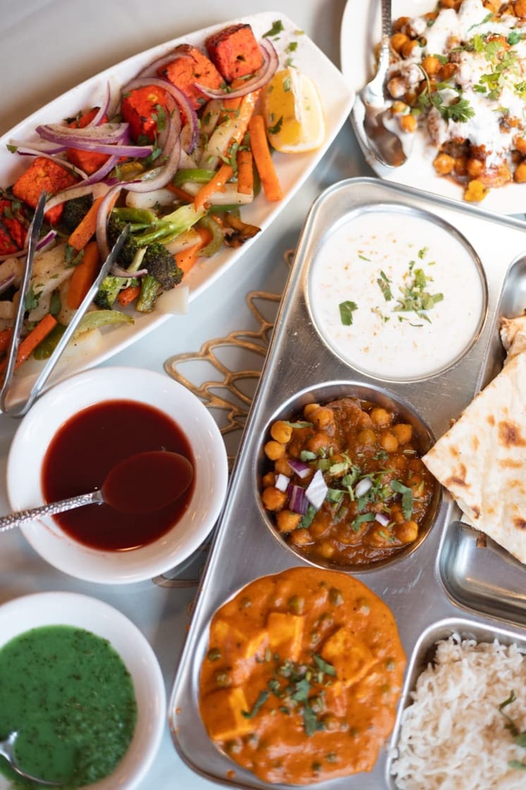 Thali tray with tandoor, curries, raita, naan and chutneys at Jewel of India Seattle